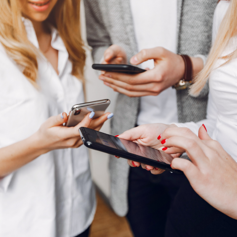Teilnehmende einer LinkedIn-Schulung für den Küchenfachhandel arbeiten gemeinsam an ihren Profilen auf dem Smartphone.